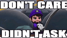 a man in a purple hat is driving a car with the words `` don 't care didn 't ask ''