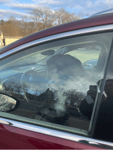 a man is taking a picture of himself in a car window