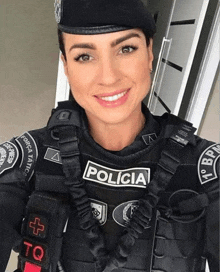 a woman in a black uniform with the word policia on her chest