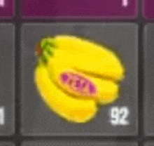 a bunch of yellow bananas with a purple sticker on them are on a keyboard .