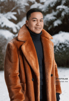 a man wearing a brown fur coat and a black turtleneck is standing in the snow