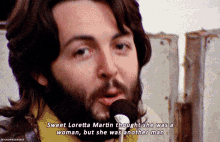 a man with a beard singing into a microphone with the words sweet loretta martin thought she was a woman