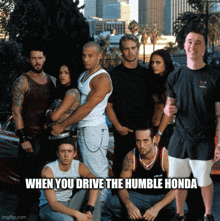 a group of people posing in front of a car with the caption when you drive the humble honda