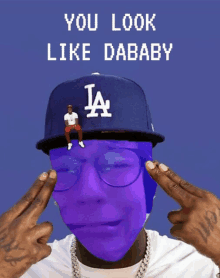 a man wearing a la hat and glasses with the words you look like dababy