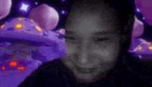 a person is smiling in front of a purple background with mushrooms