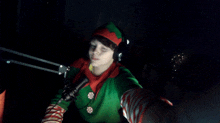 a person in an elf costume taking a selfie in front of a microphone