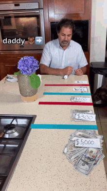 a man sits at a counter with a bunch of money and a sign that says $ 500 on it