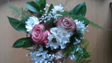 a bouquet of pink and white flowers with baby 's breath