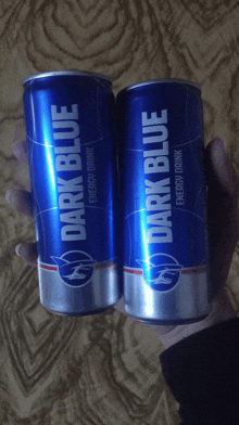 two blue cans of dark blue energy drink