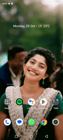 a phone screen shows a woman smiling and the date monday 28 oct