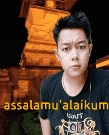 a man wearing a black shirt that says " assalamu ' alaikum "