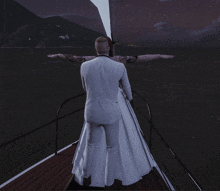 a man in a suit and a woman in a wedding dress are standing on a boat