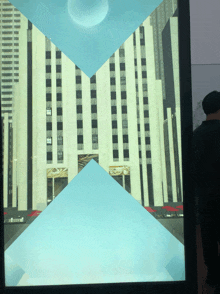 a man stands in front of a painting of a building that says ' allianz '