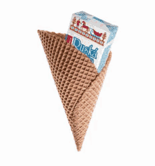 a waffle cone with a box of duska ice cream on it .