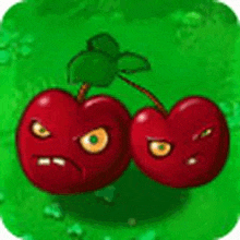 a couple of cherries with angry faces on them are sitting on a green field .