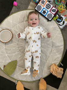 a baby is laying on a play mat and smiling for the camera