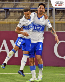 two soccer players wearing blue and white jerseys that say bice