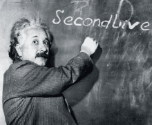 albert einstein is writing on a blackboard that says second live