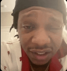 a close up of a man 's face with a black headband on