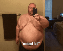 a man taking a picture of himself with the words " embed fail " above him