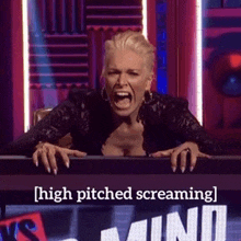 a woman is screaming while sitting in front of a sign that says high pitched screaming