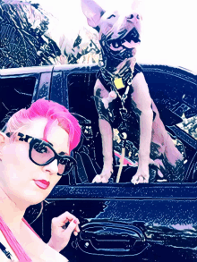 a woman with pink hair is smoking a cigarette next to a dog in a car