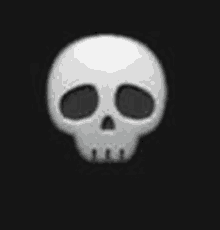 a white skull with black eyes is sitting on a black background .