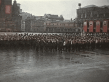 a large crowd of people are gathered in front of a building with a sign that says ' soviet union ' on it