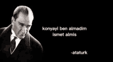 a black and white photo of a man in a suit and tie with a quote from ataturk