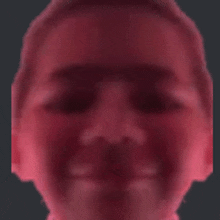 a blurry picture of a person 's face with a red background .