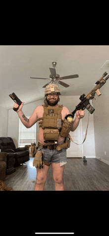 a man in a helmet and shorts is holding a rifle and a gun