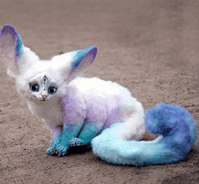 a stuffed animal with purple and blue ears and tail