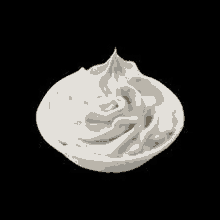 whipped cream in a small bowl on a black background .