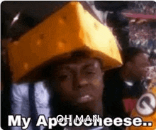 a man is wearing a cheese hat and saying `` my aphmanese ... '' .