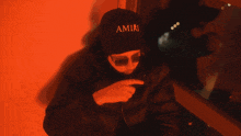 a man wearing sunglasses and a hat that says jaima on it
