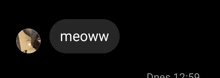 a black button with the word meoww on it