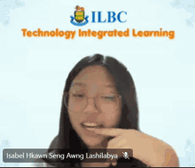 a girl wearing glasses is pointing at her mouth in front of a screen that says technology integrated learning