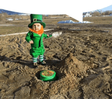 a little boy dressed as a leprechaun is standing in the sand