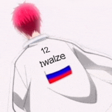 a man with red hair is wearing a white jacket with the name twalze on the back .