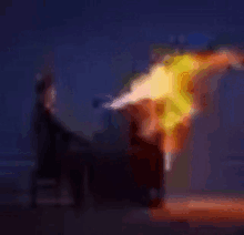 a blurry picture of a person holding a torch in the dark