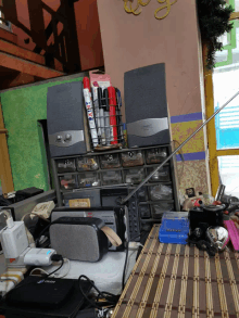 a stack of speakers sits on a table next to a box that says ' sharpie '