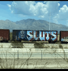 a train car with the word sluts written on it