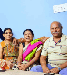 a man and two women are posing for a picture