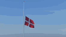 a red and white flag flies in the wind