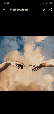 a phone screen shows a painting of two hands reaching out towards each other with a cloudy sky in the background