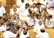 a man in a white shirt is being lifted in the air by a group of people