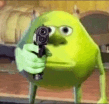 mike wazowski from monsters inc is holding a gun in front of his face .