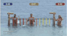 a group of people are standing in the water with the time displayed at 0:47