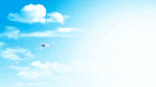 a white airplane is flying through a blue sky with white clouds .