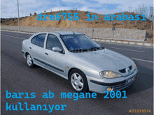 a picture of a silver car with the words paris ab megane 2001